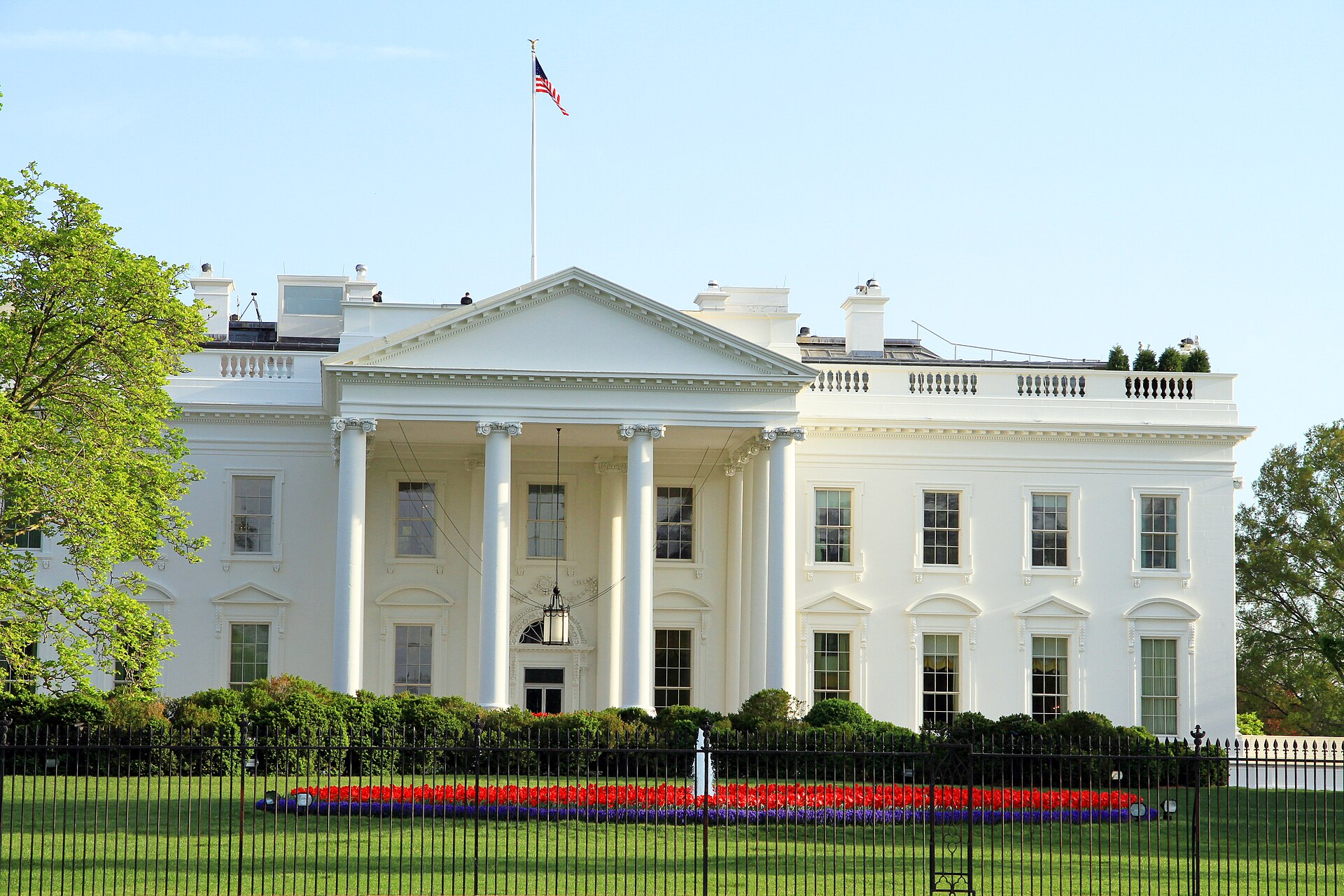 The White House with an American flag flying above it.