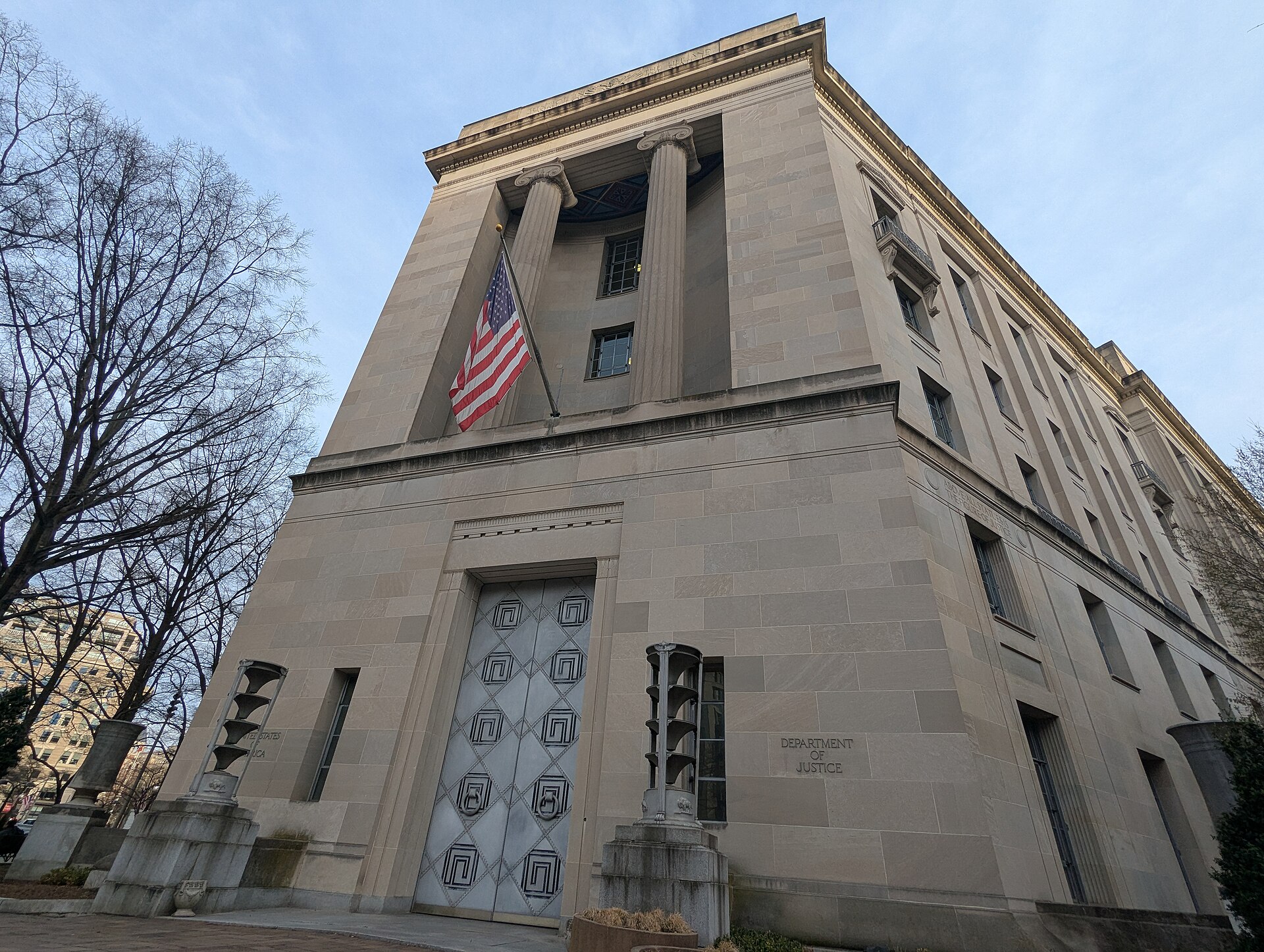 The Department of Justice building in Washington D.C. with an American flag flying.