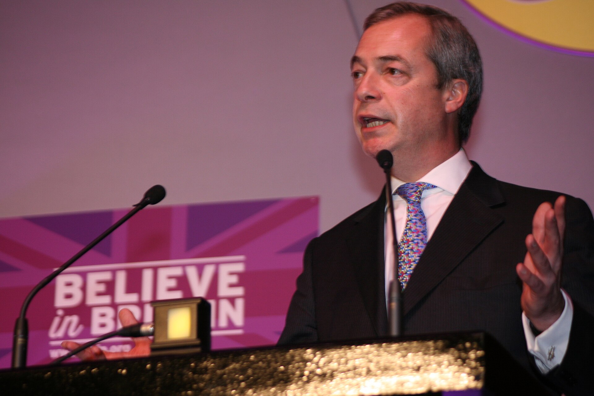 Nigel Farage speaking at a podium