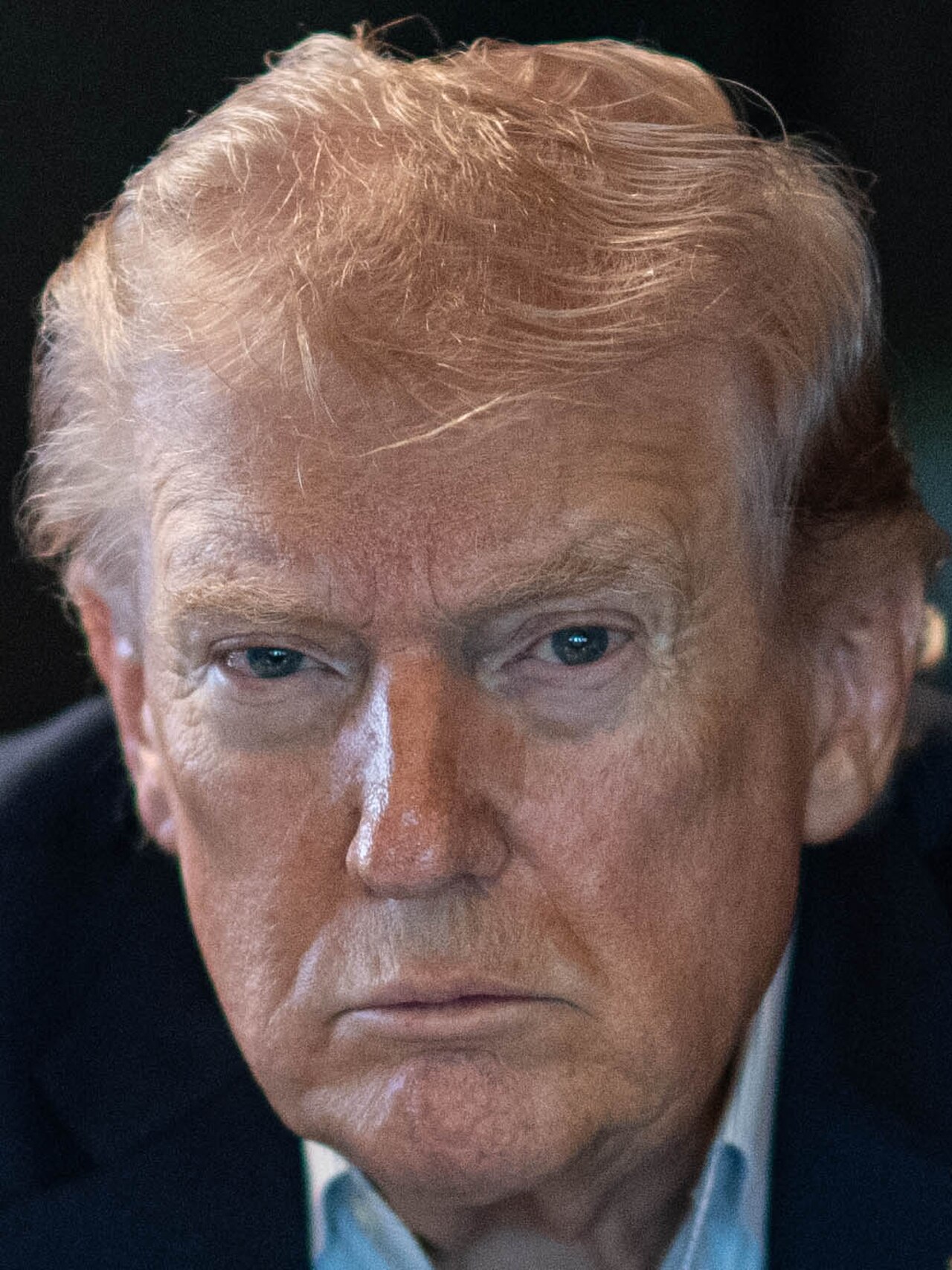 A close-up of Donald Trump's face, showing his distinctive features and expression.
