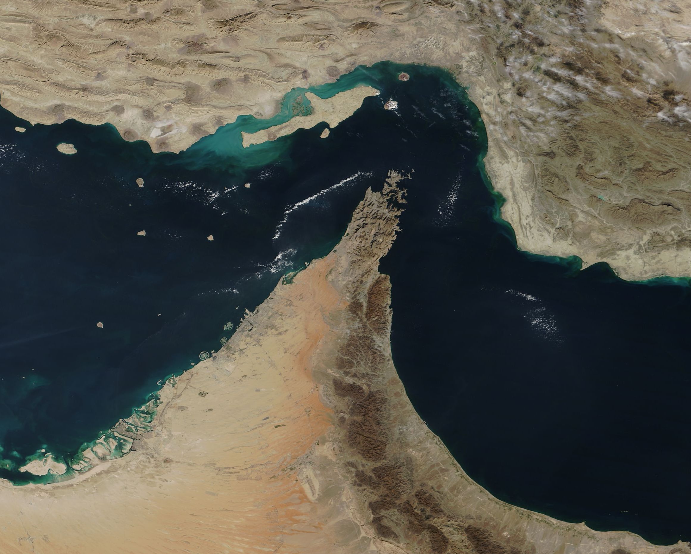 Aerial view of the Strait of Hormuz, showing the body of water separating the Middle Eastern countries of Iran and Oman.