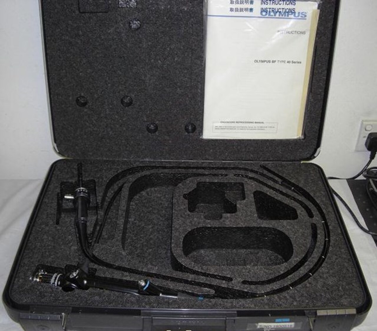 An Olympus bronchoscope in its case with instructions.