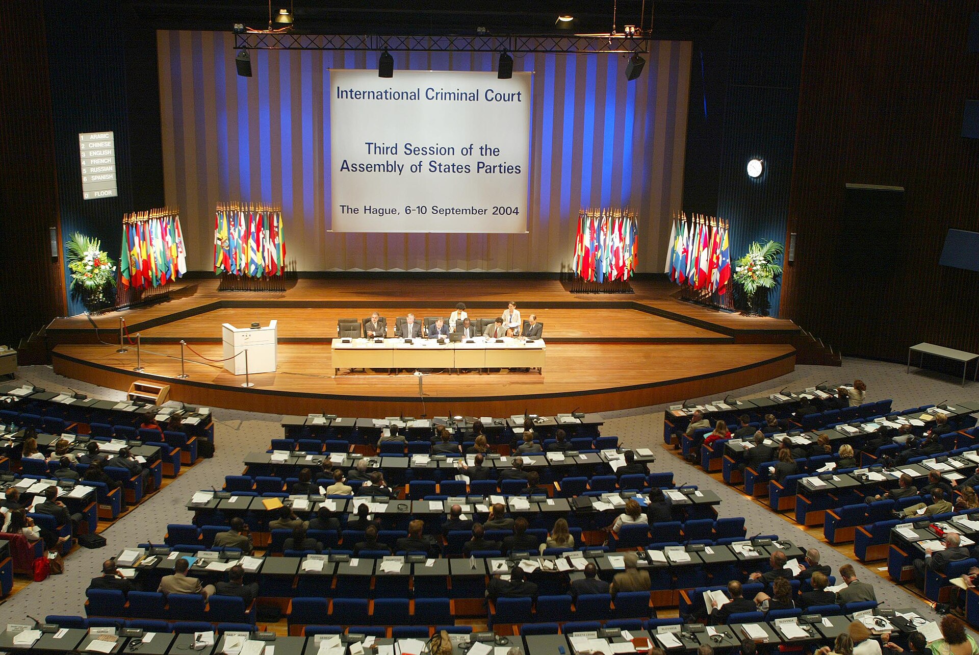 International Criminal Court assembly hall with people seated at desks