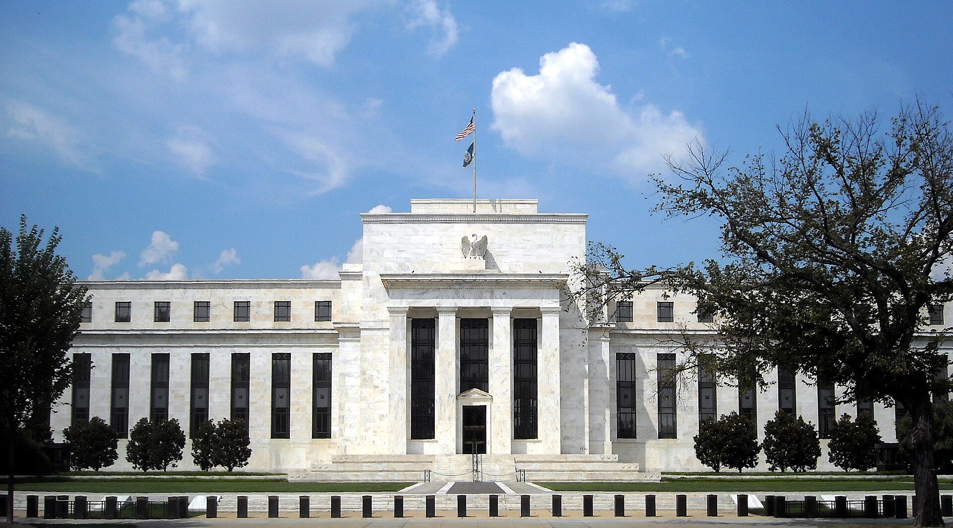 The white marble facade of the United States Federal Reserve building in Washington, D.C.