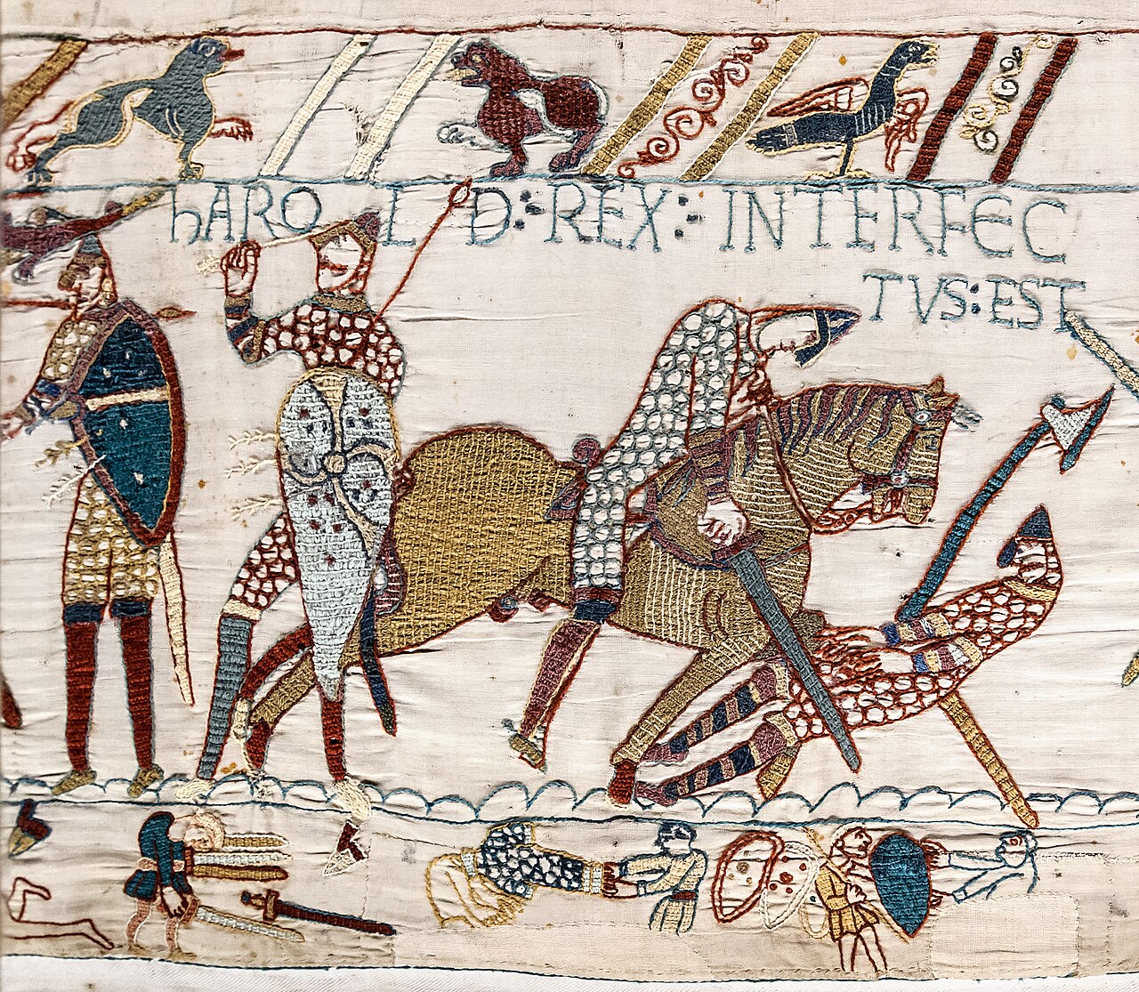A section of the Bayeux Tapestry depicting a battle scene with embroidered figures on horseback and on foot, with Latin text above them.