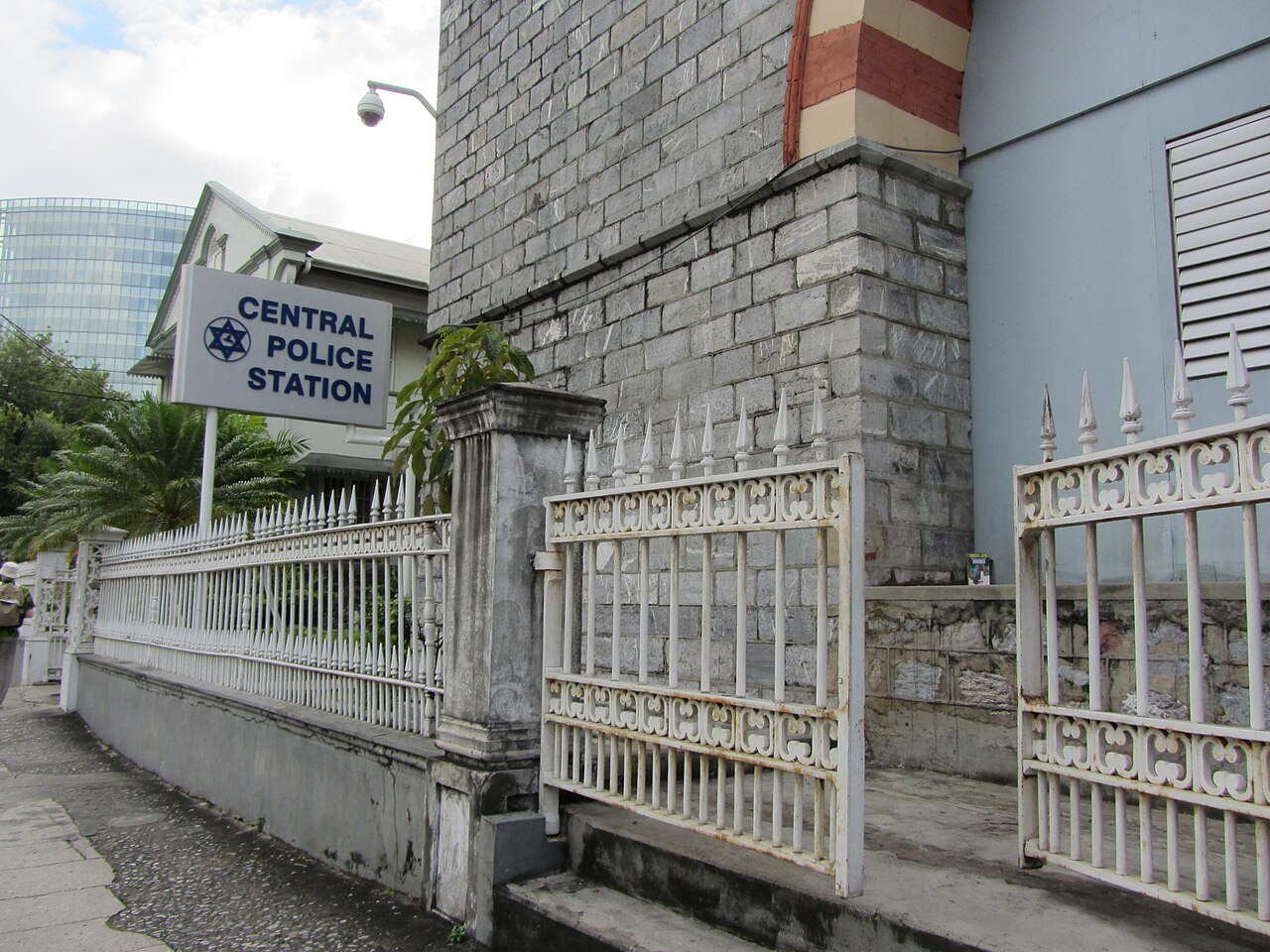 Central Police Station sign on a building with a white fence