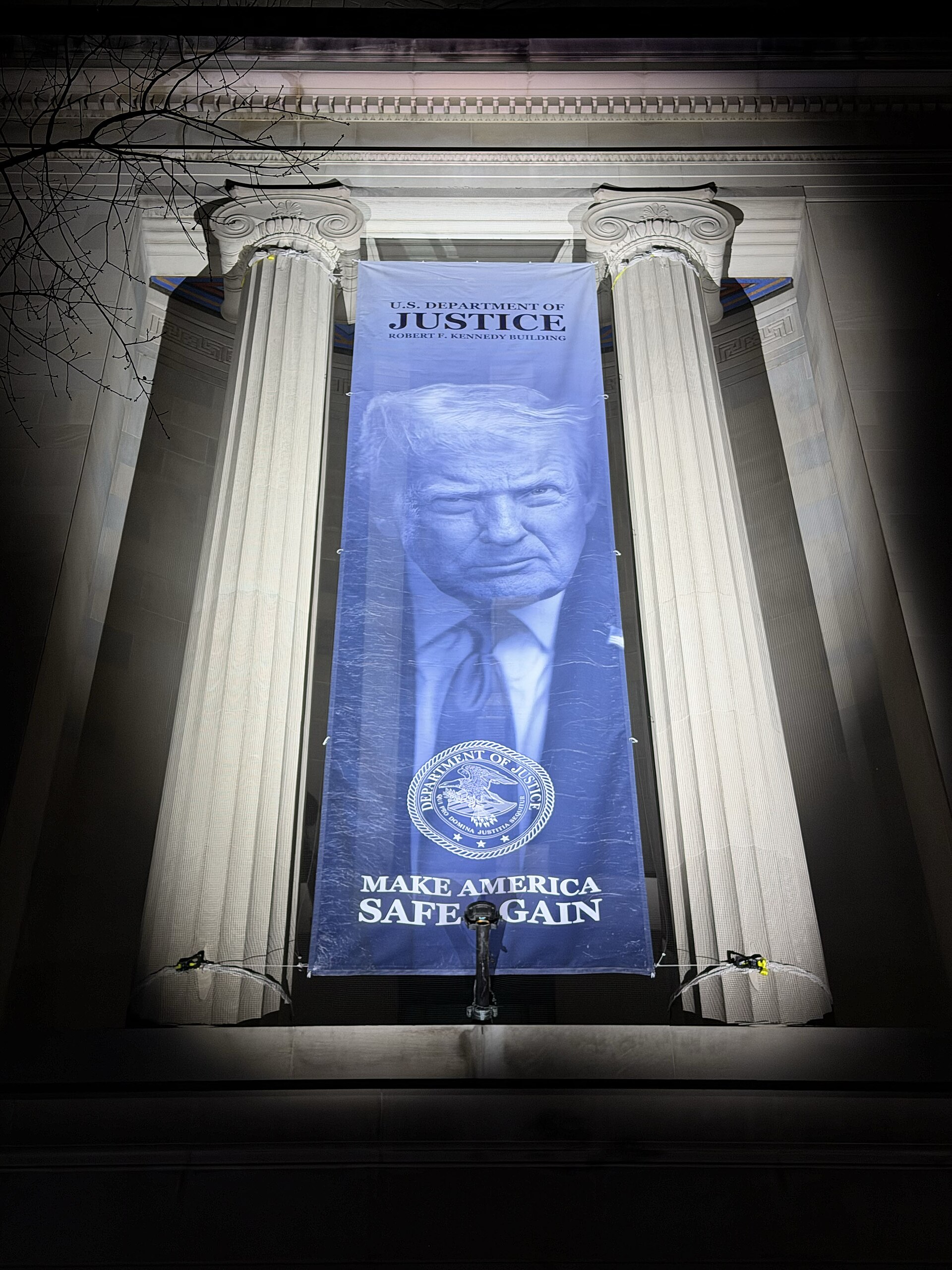 banner of Donald Trump on a building with columns