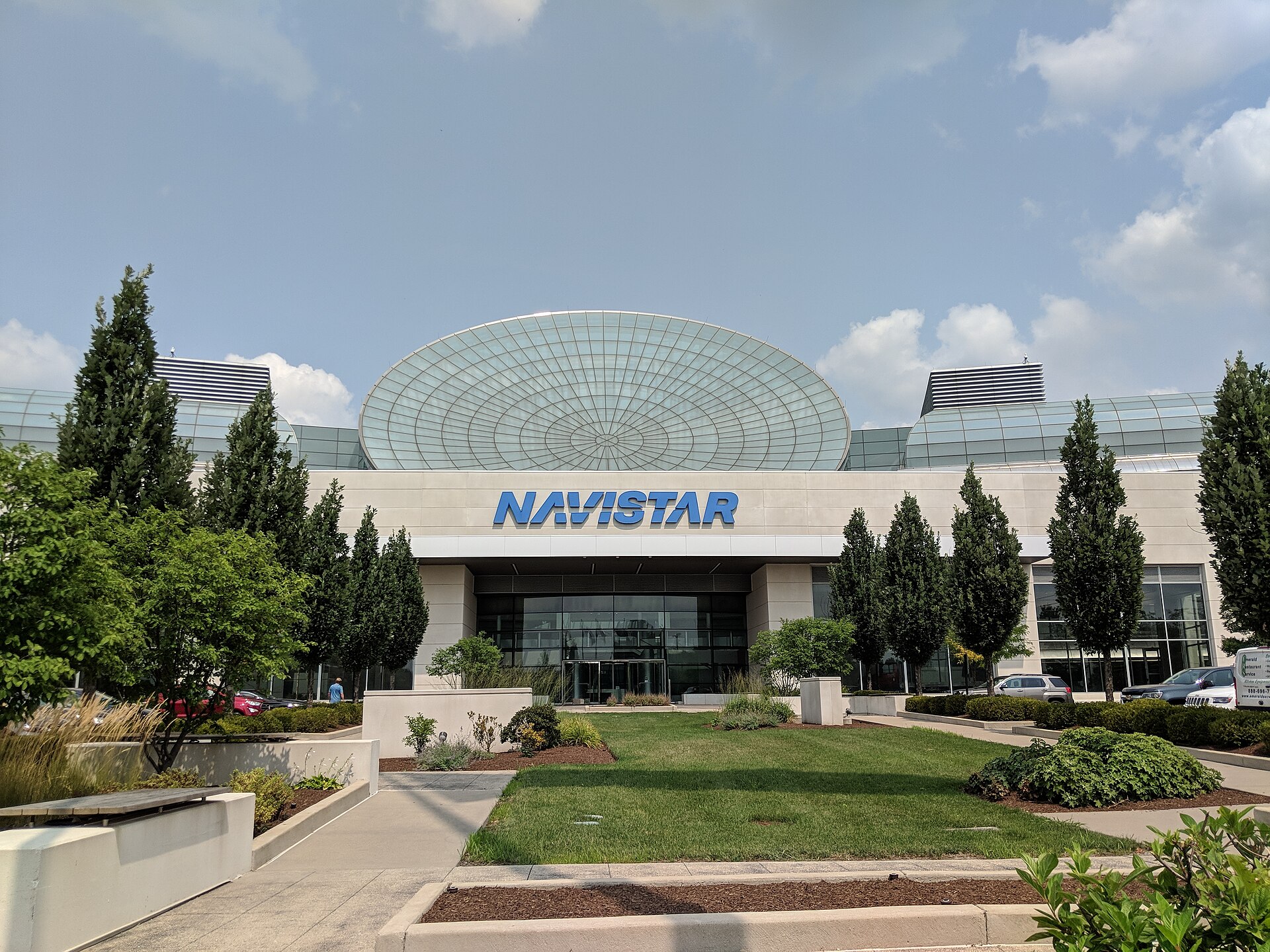A large building with a glass dome roof and a sign that reads Navistar