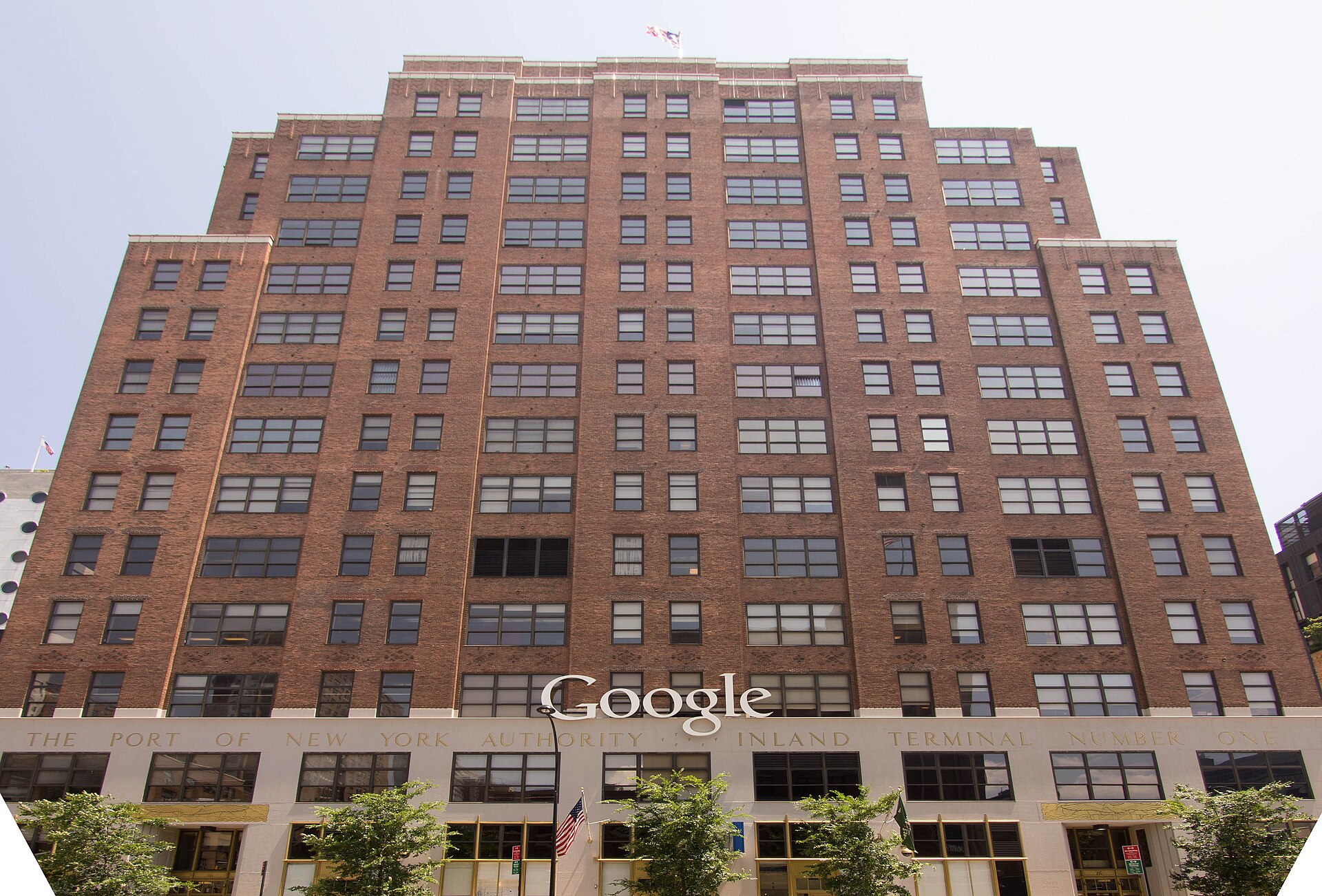 A large brick building with many windows and a sign that reads Google