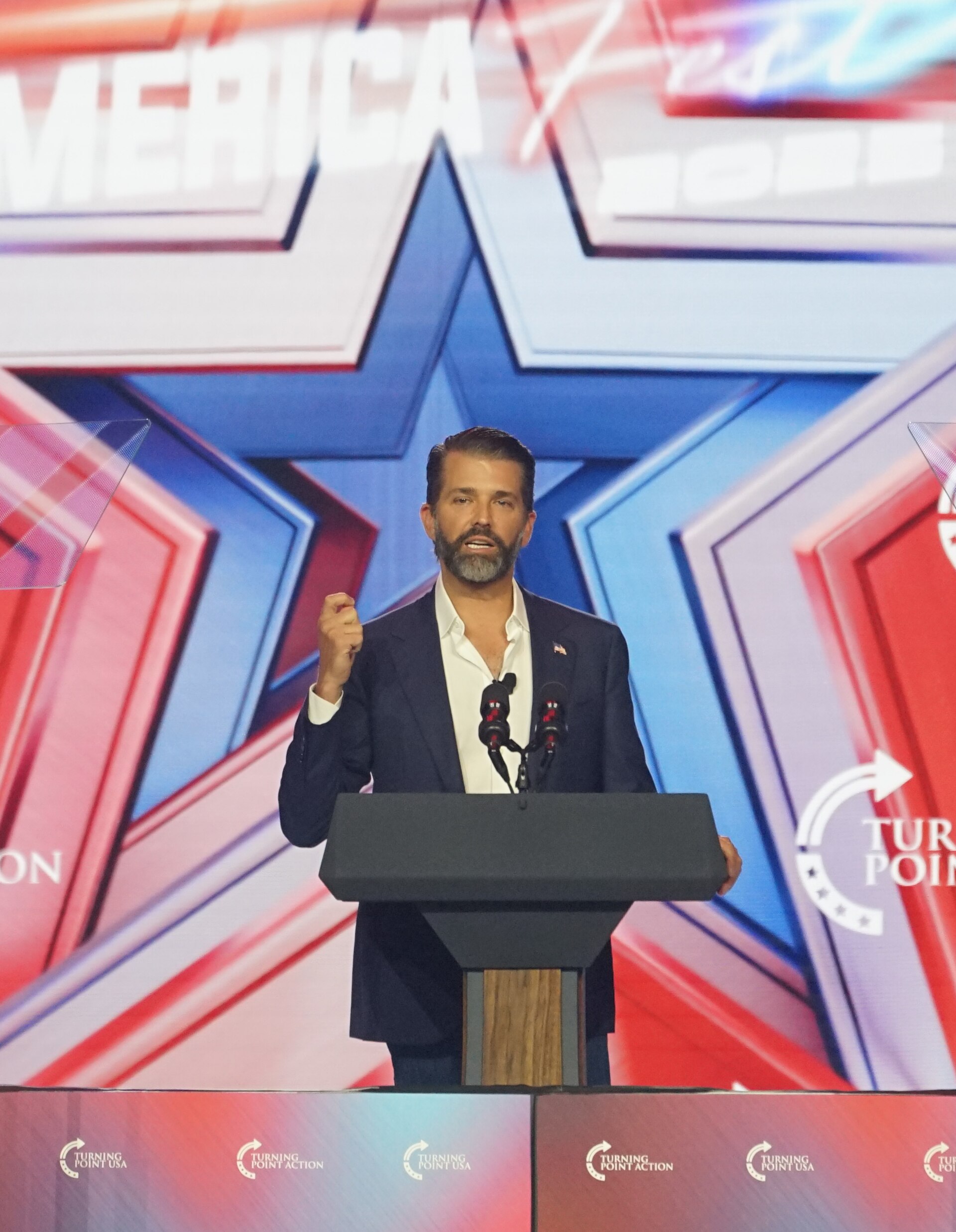 Donald Trump Jr. speaking at a podium