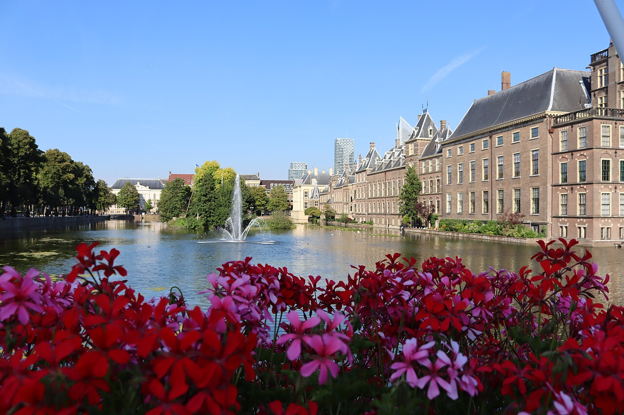 The Binnenhof, the Dutch parliament complex in The Hague, seen across the Hofvijver pond on a clear day.