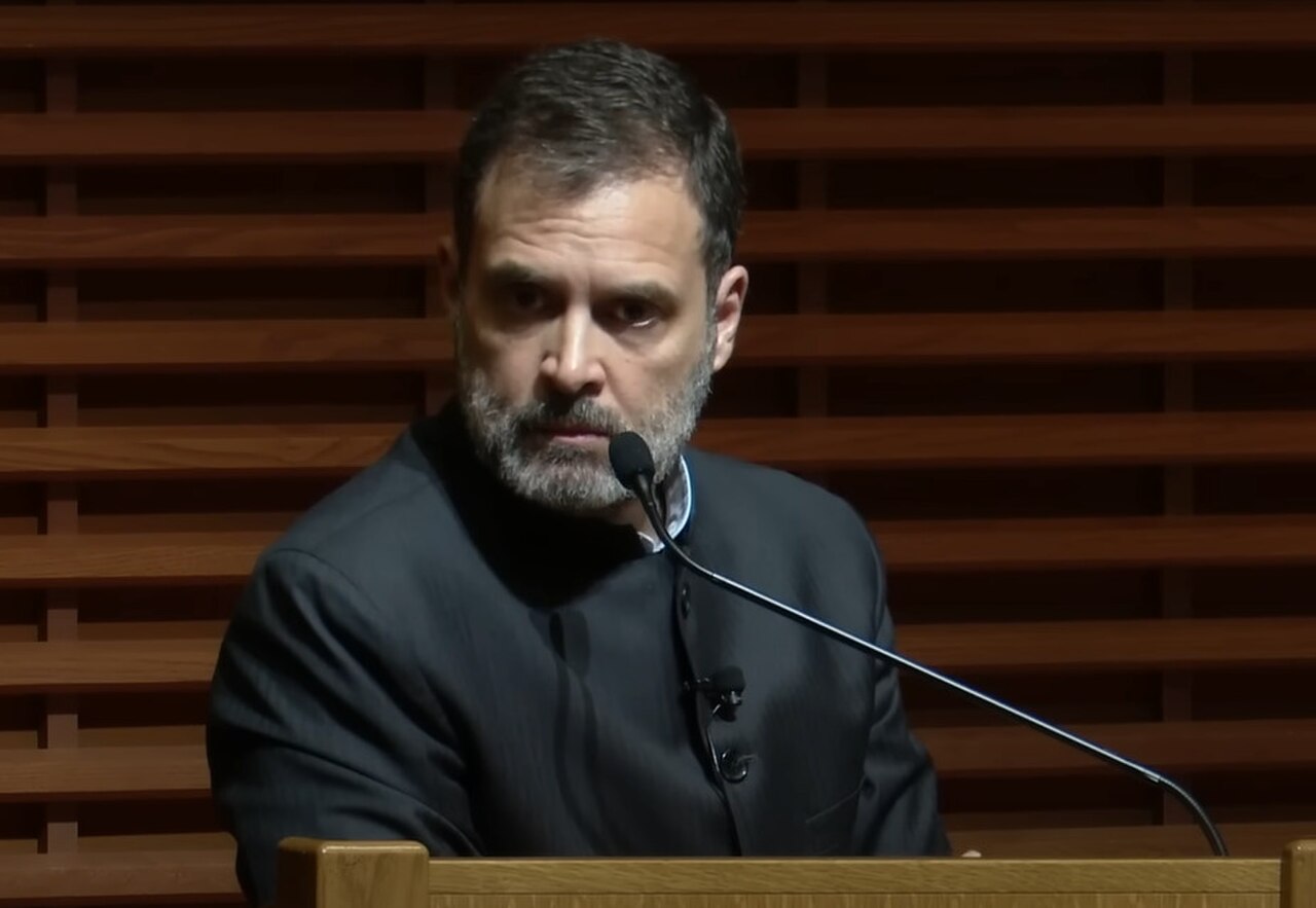 Rahul Gandhi speaking at a podium with a microphone