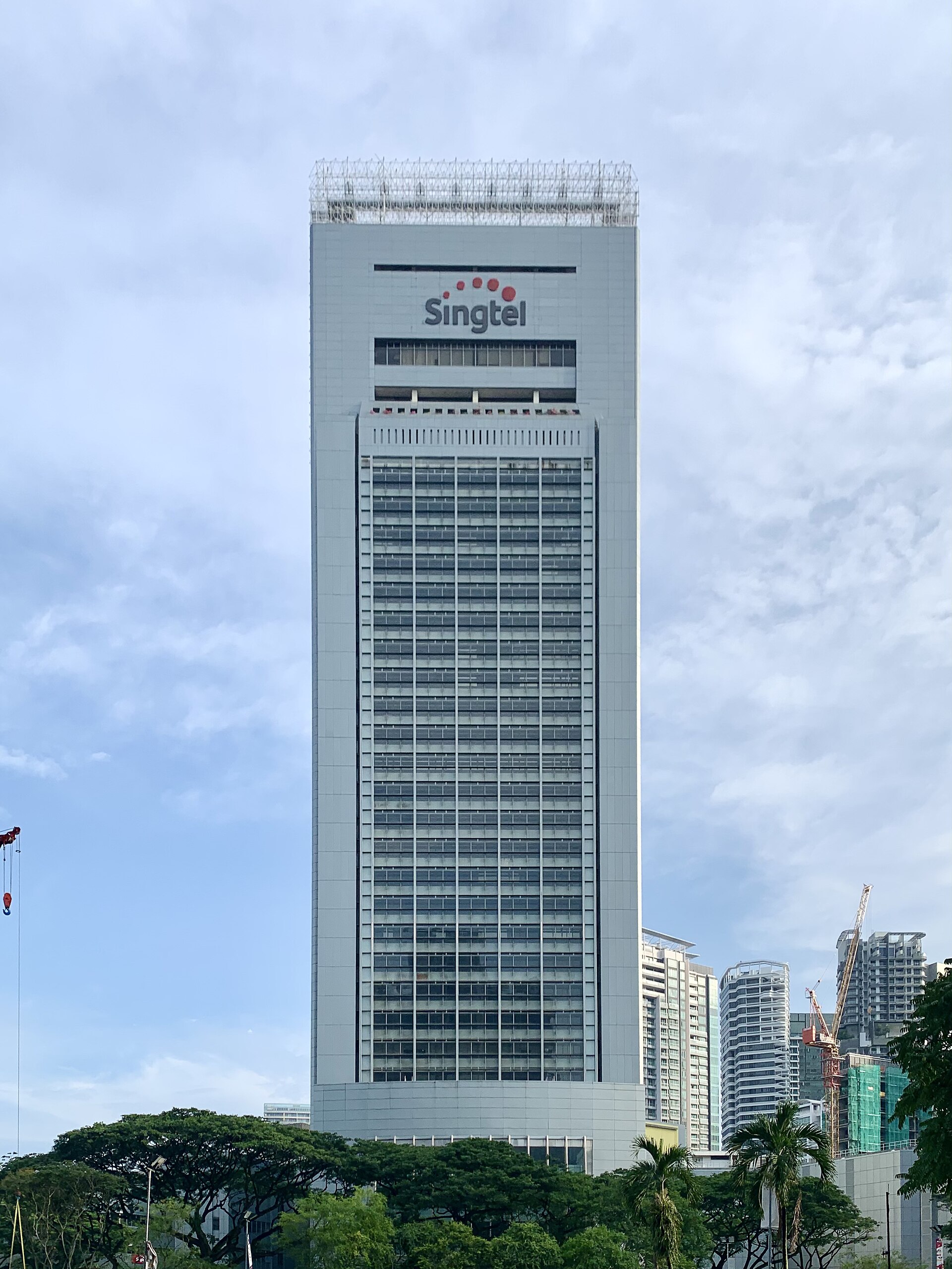 A tall building with the Singtel logo on top