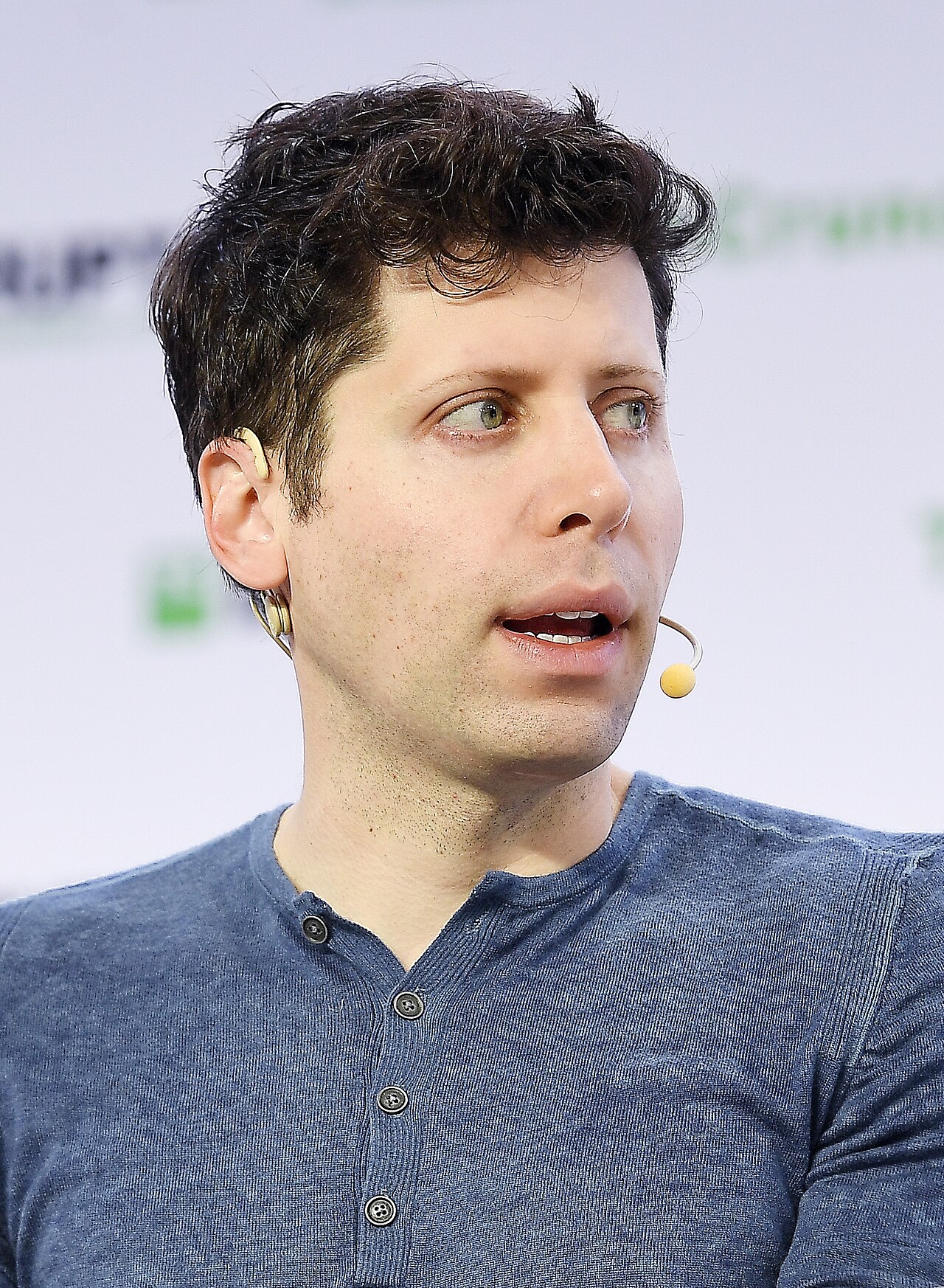 OpenAI CEO Sam Altman speaking on stage at TechCrunch Disrupt