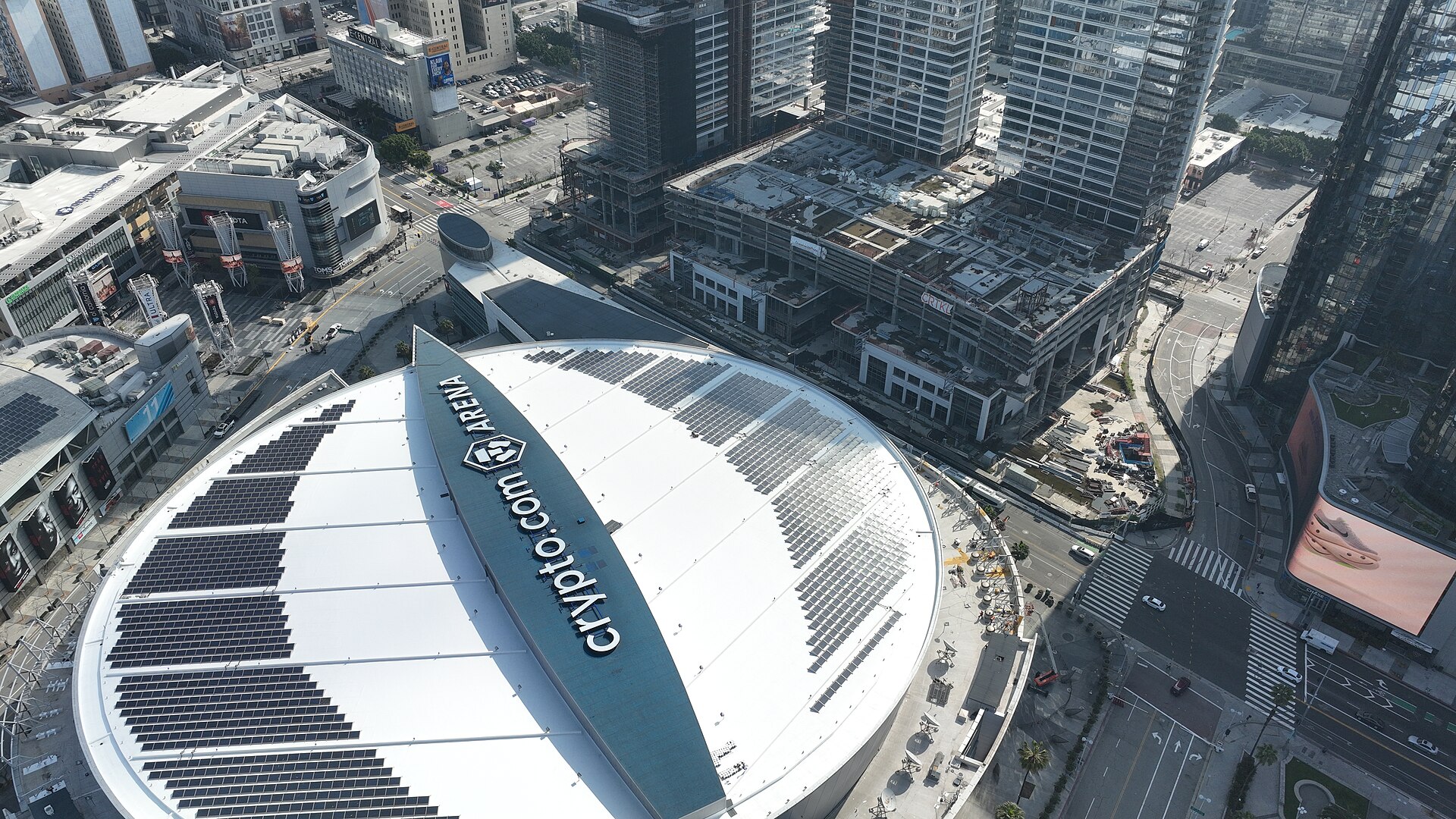Aerial view of Crypto.com Arena in Los Angeles, California, with surrounding cityscape and buildings.