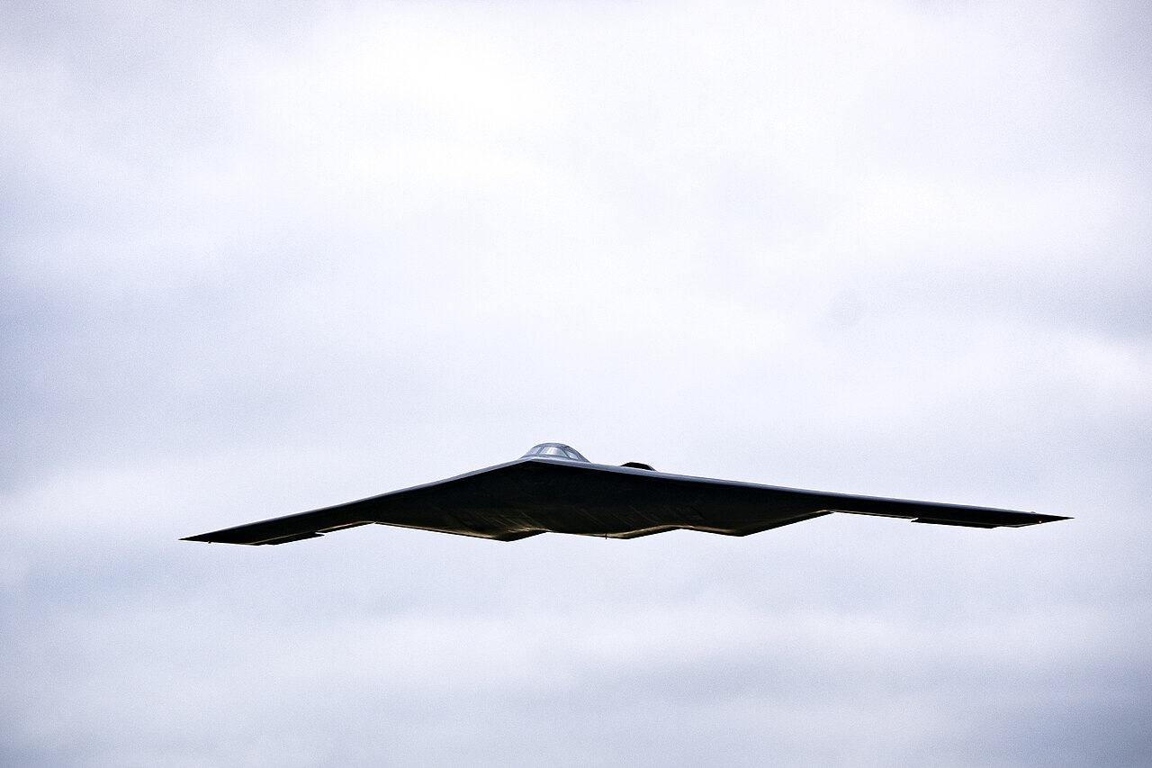 a black flying wing aircraft in the sky