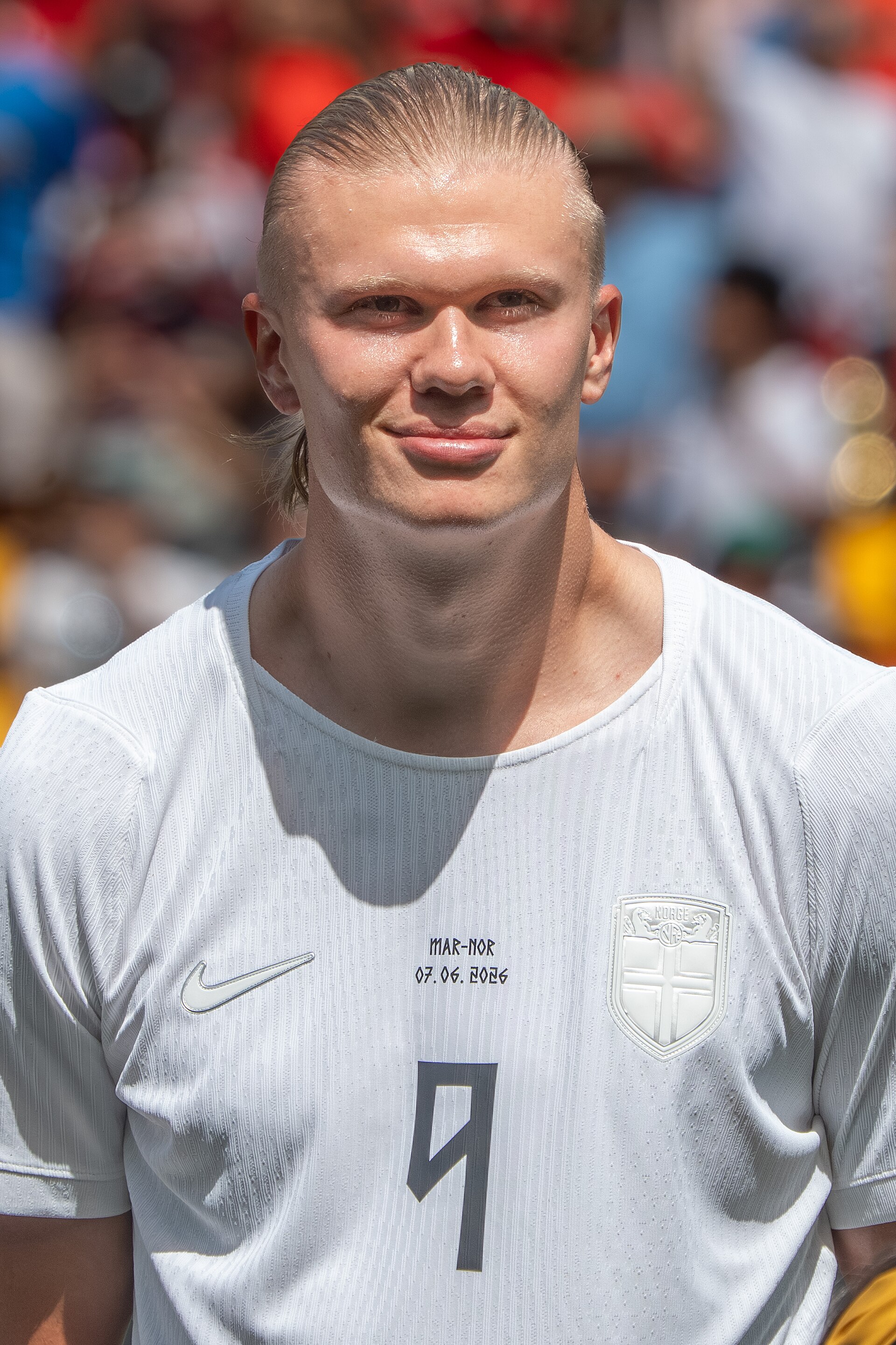 Erling Haaland in a white soccer jersey with a number 9 on it