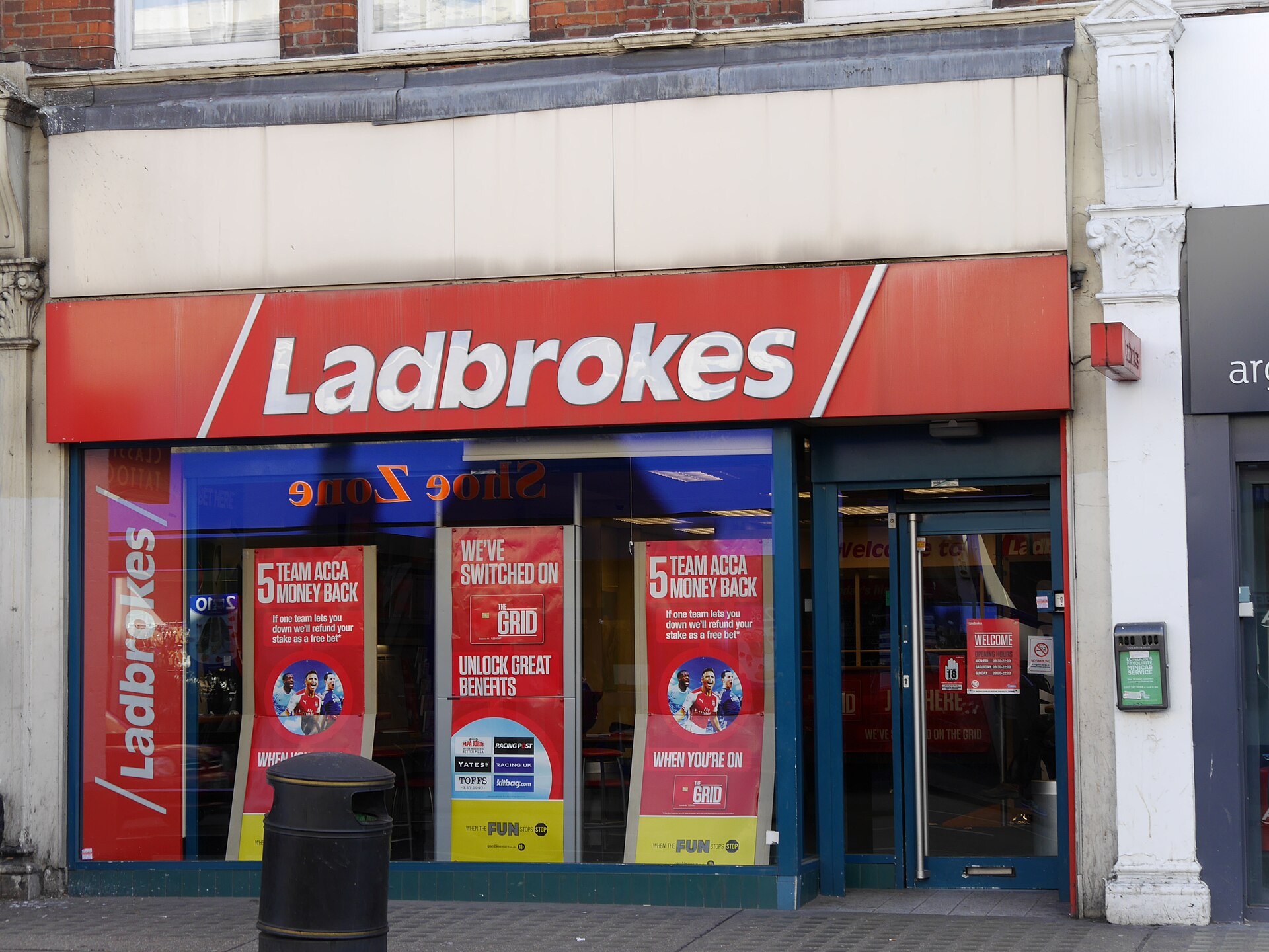 Ladbrokes storefront with red awning and white lettering