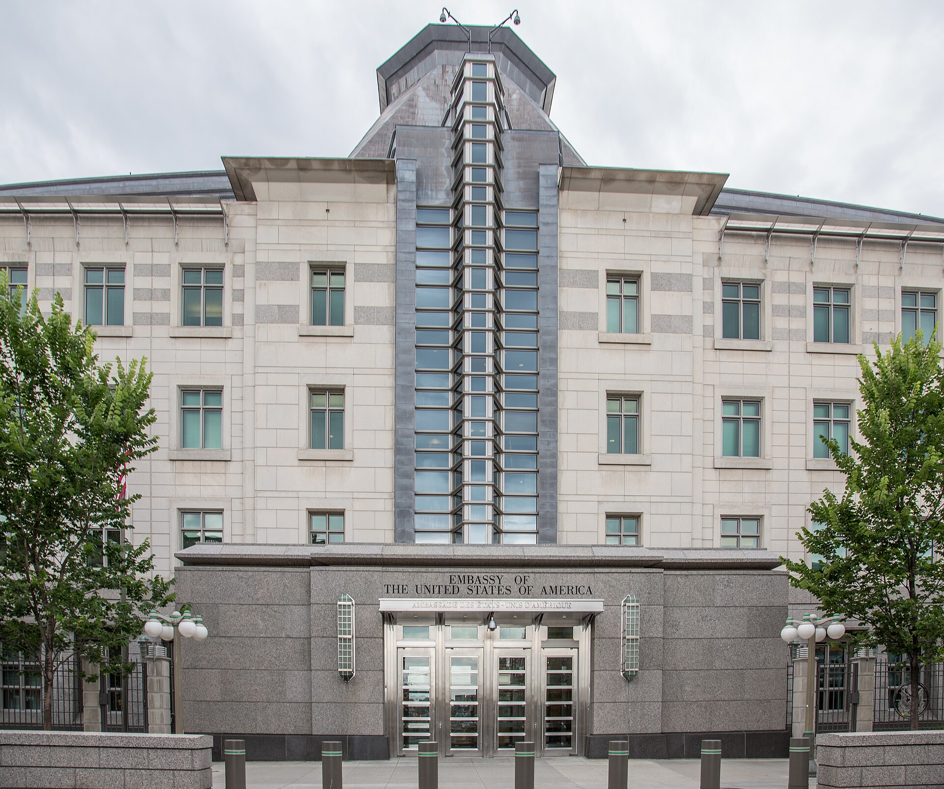 The Embassy of the United States of America building in Ottawa, Canada, with its distinctive facade featuring stone cladding, large windows, and a central entrance with glass doors.
