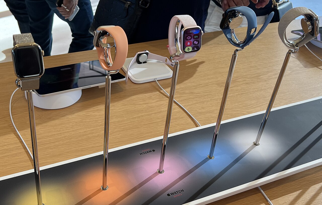 A row of Apple Watch Series 9 models on display stands in an Apple store.