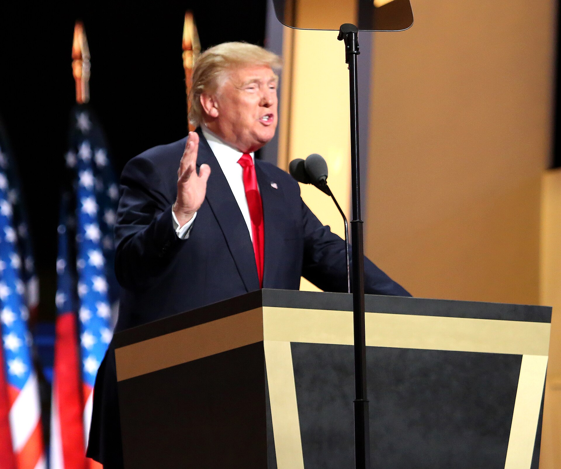 Donald Trump speaking at a podium