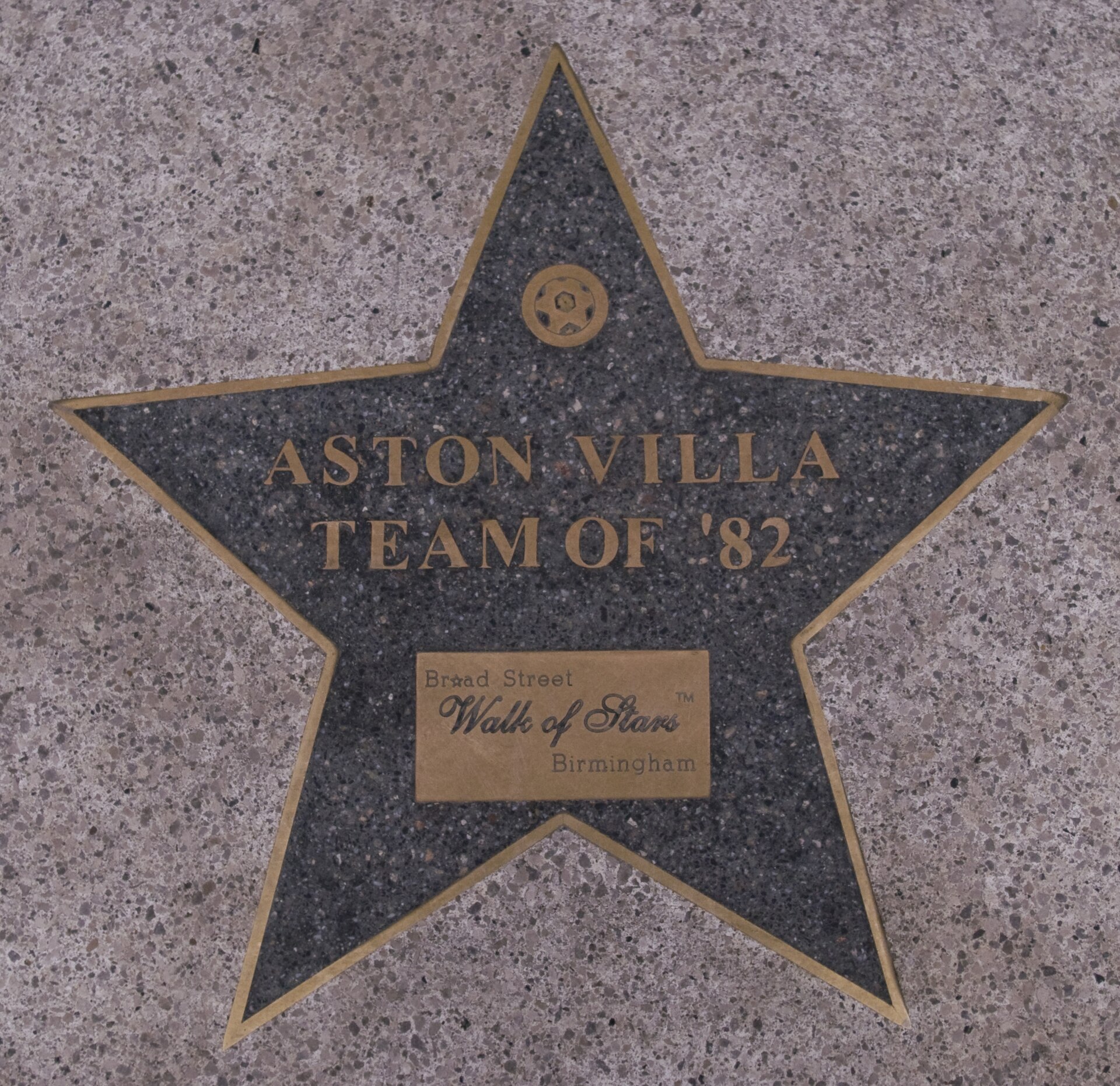 A star-shaped plaque embedded in a speckled pavement reads 'Aston Villa Team of '82' and 'Broad Street Walk of Stars Birmingham'.