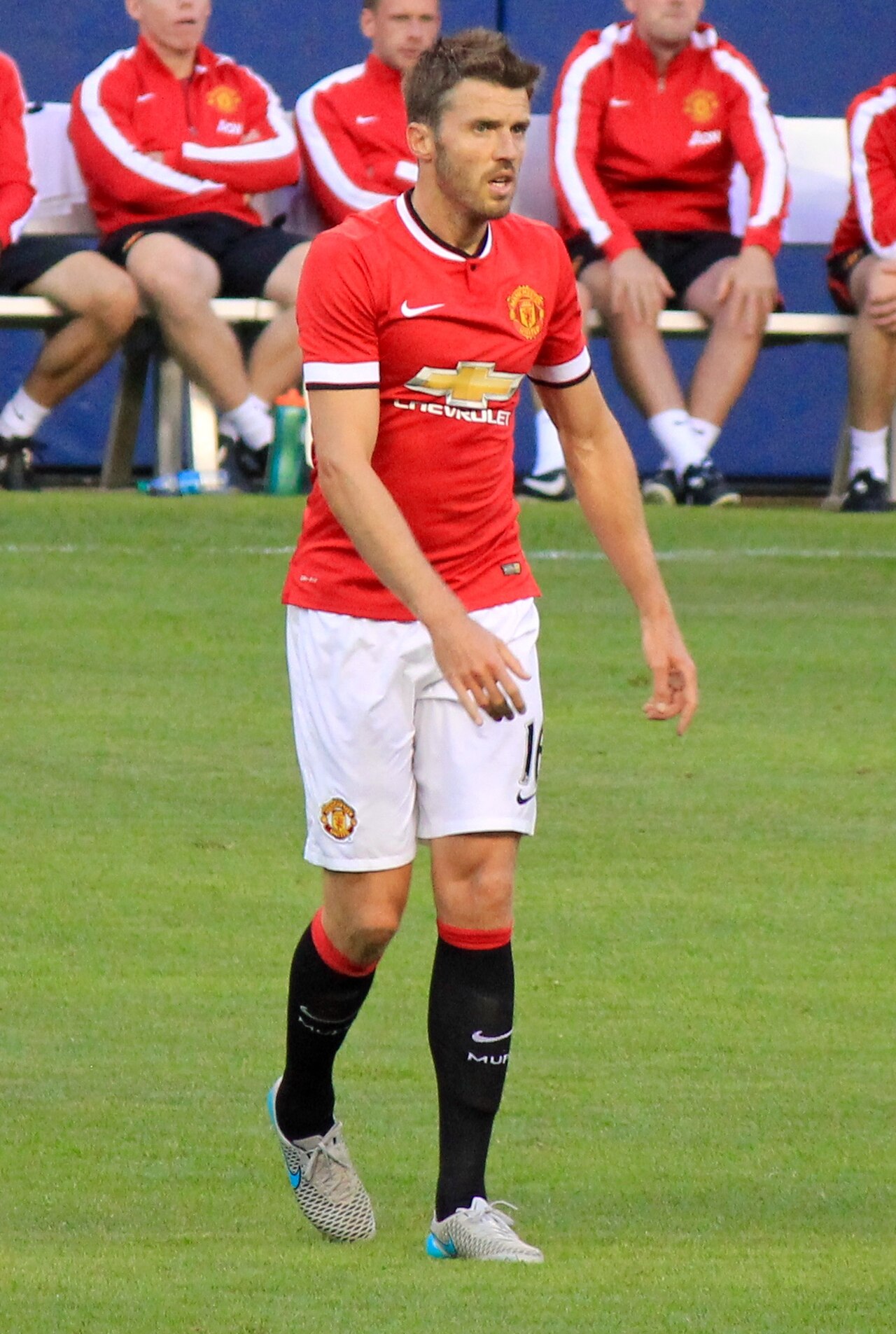 Michael Carrick in a Manchester United kit on a football pitch.