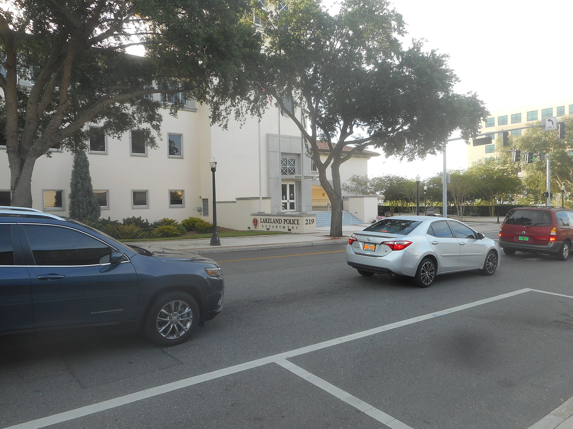 Lakeland Police Department building with a sign in front and cars parked on the street